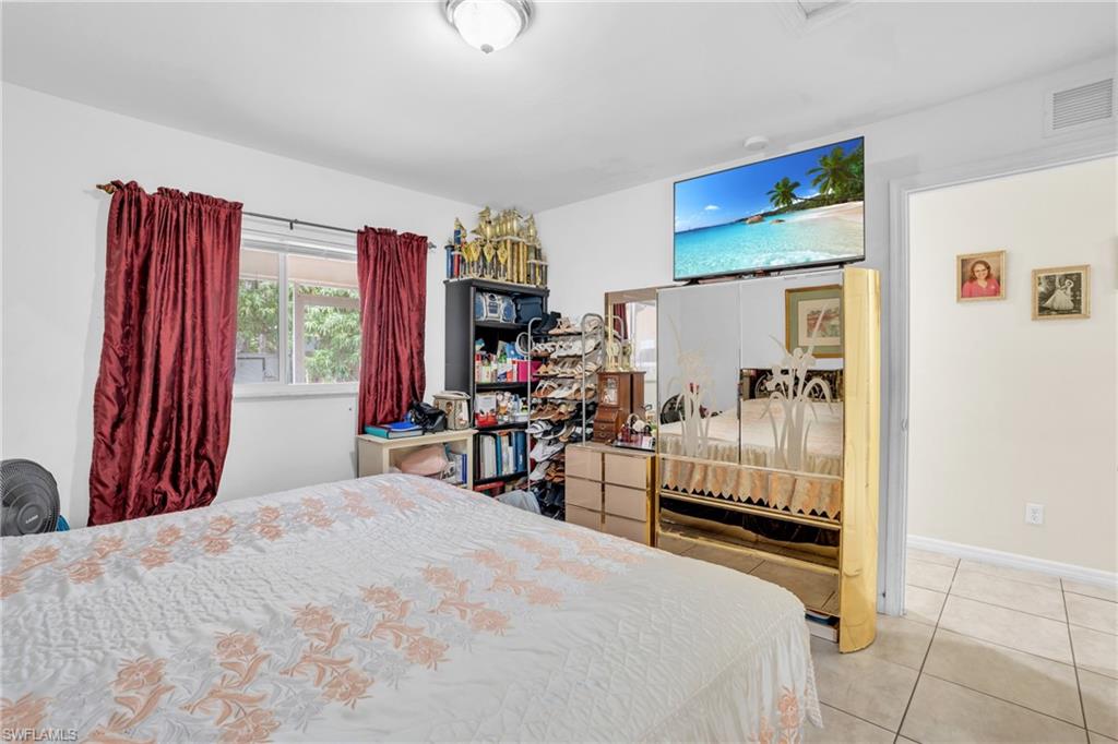 2388 55th Terrace Southwest Naples, FL 34116 - Photo 31 of 42 Bedroom featuring light tile floors