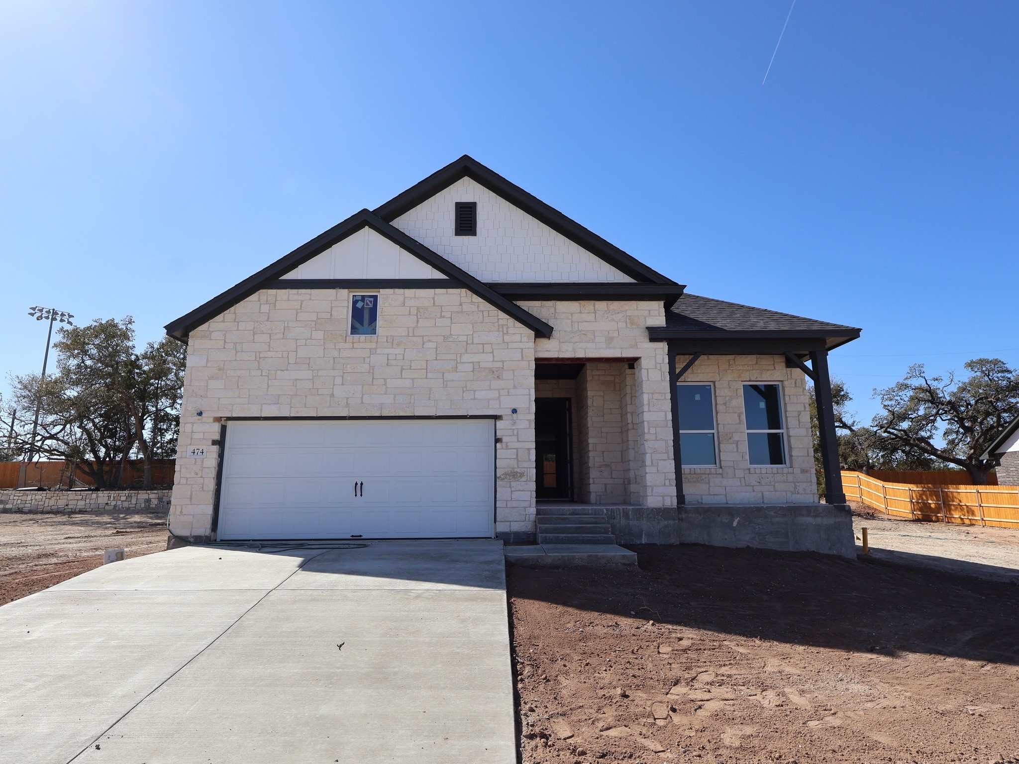 474 Bishop Wood Road Dripping Springs, TX 78620 - Photo 1 of 15 a front view of a house with a yard and garage