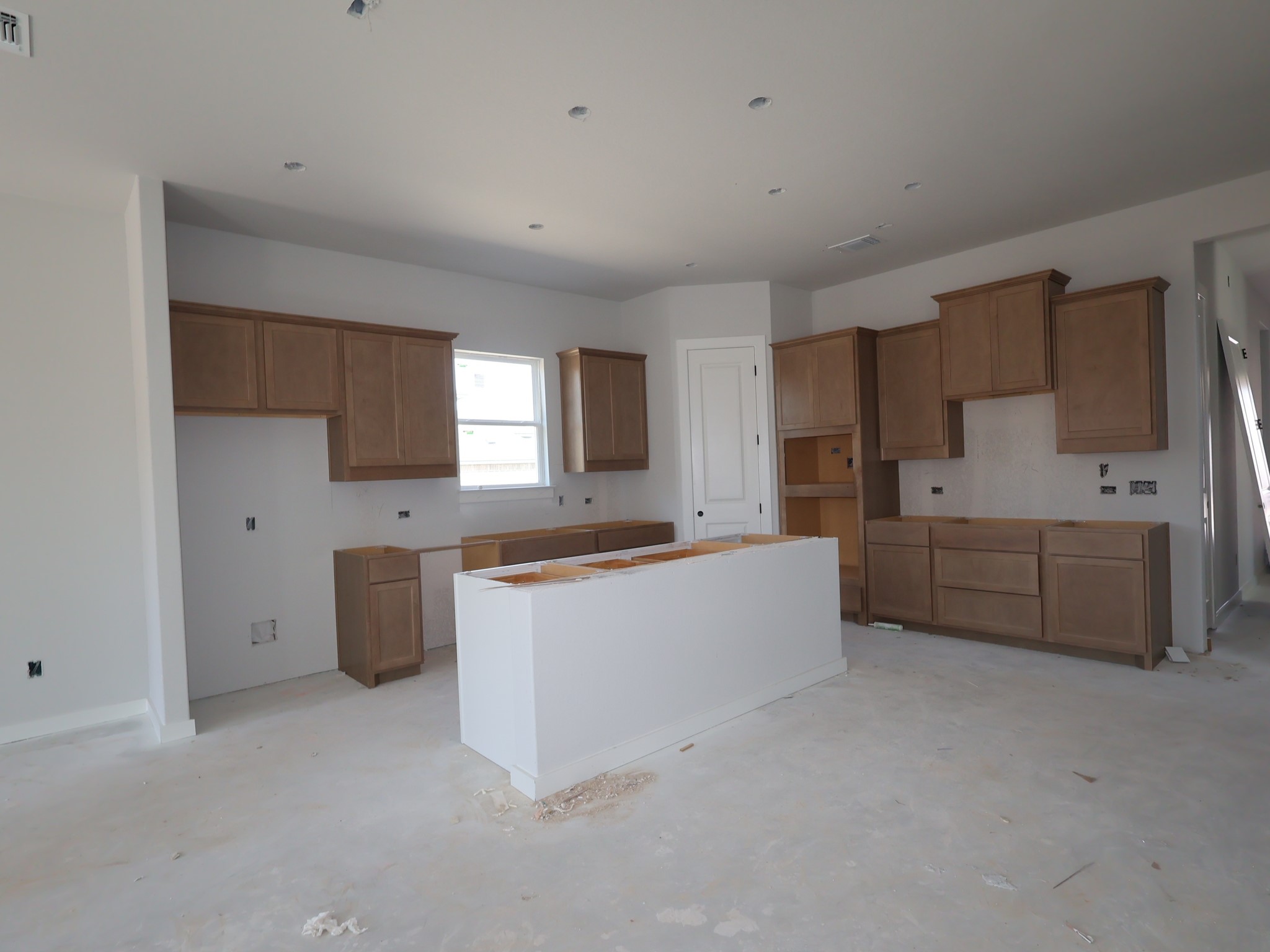 474 Bishop Wood Road Dripping Springs, TX 78620 - Photo 3 of 15 a large kitchen with a lot of cabinets and wooden floor