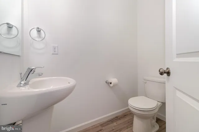 a bathroom with a sink mirror and toilet