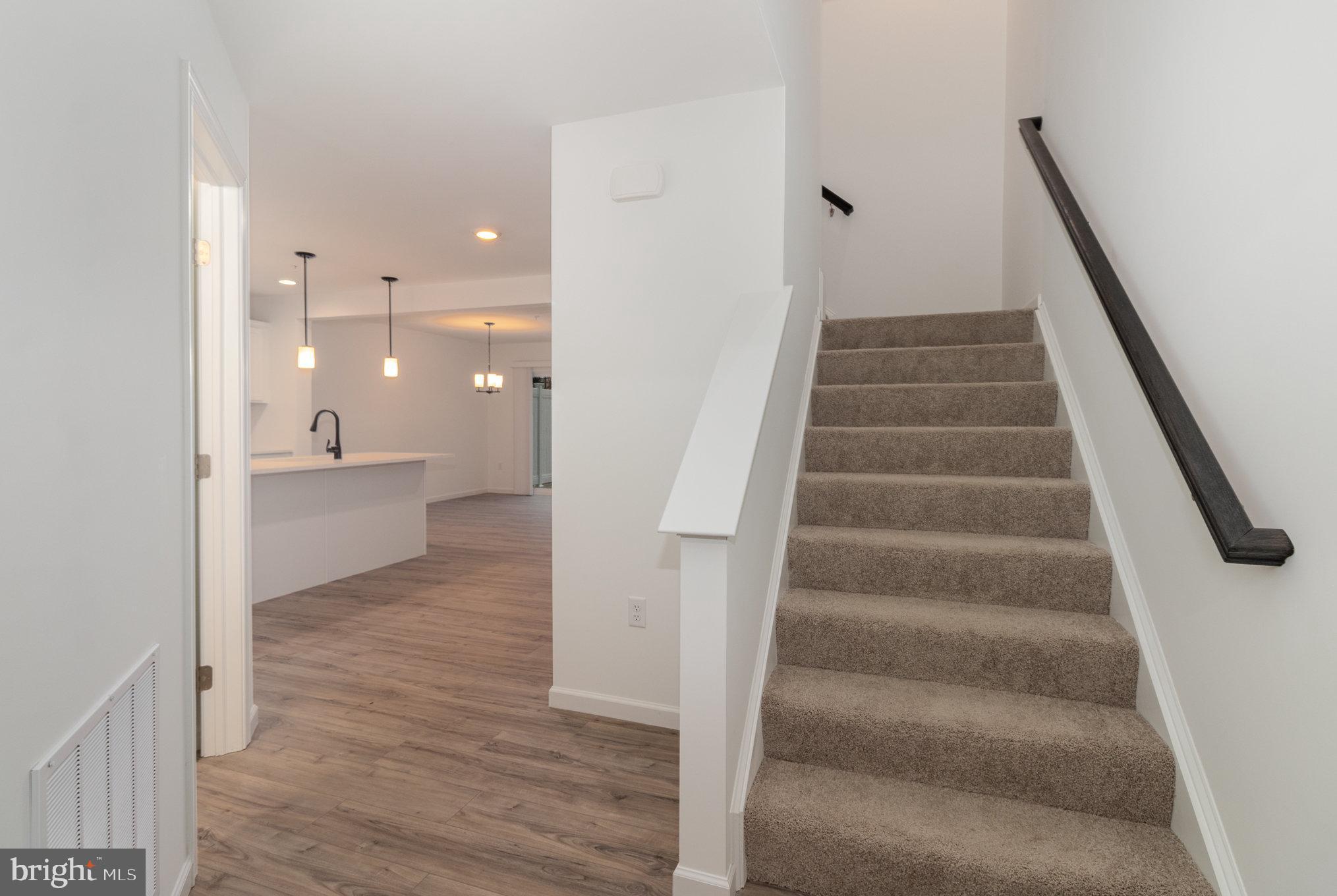 104 Emma Circle Harrisburg, PA 17112 - Photo 4 of 29 a view of a hallway with wooden floor and staircase
