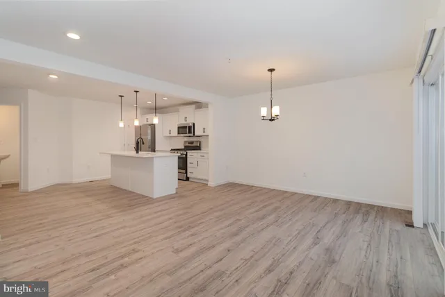 a view of a kitchen with wooden floor and a sink