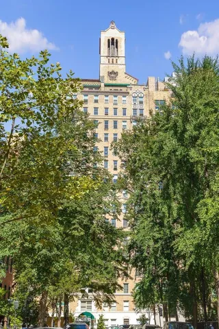 a living room with fireplace furniture and a large window