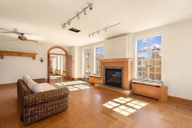a spacious bedroom with a large bed and a chandelier