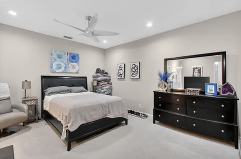 a bedroom with a bed and a dresser