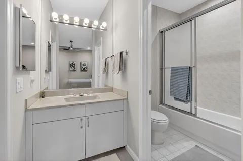 a bathroom with a sink toilet a mirror and shower