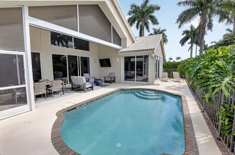 a view of a house with swimming pool and sitting area