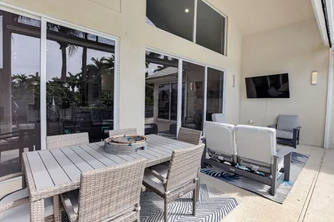 a outdoor space with patio the couches and a flat screen tv