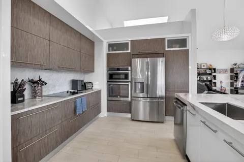 a kitchen with a refrigerator sink and cabinets
