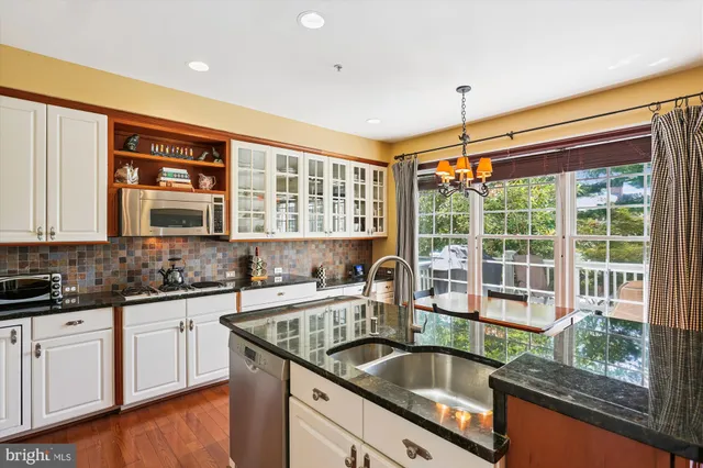 a kitchen with granite countertop a sink and a window