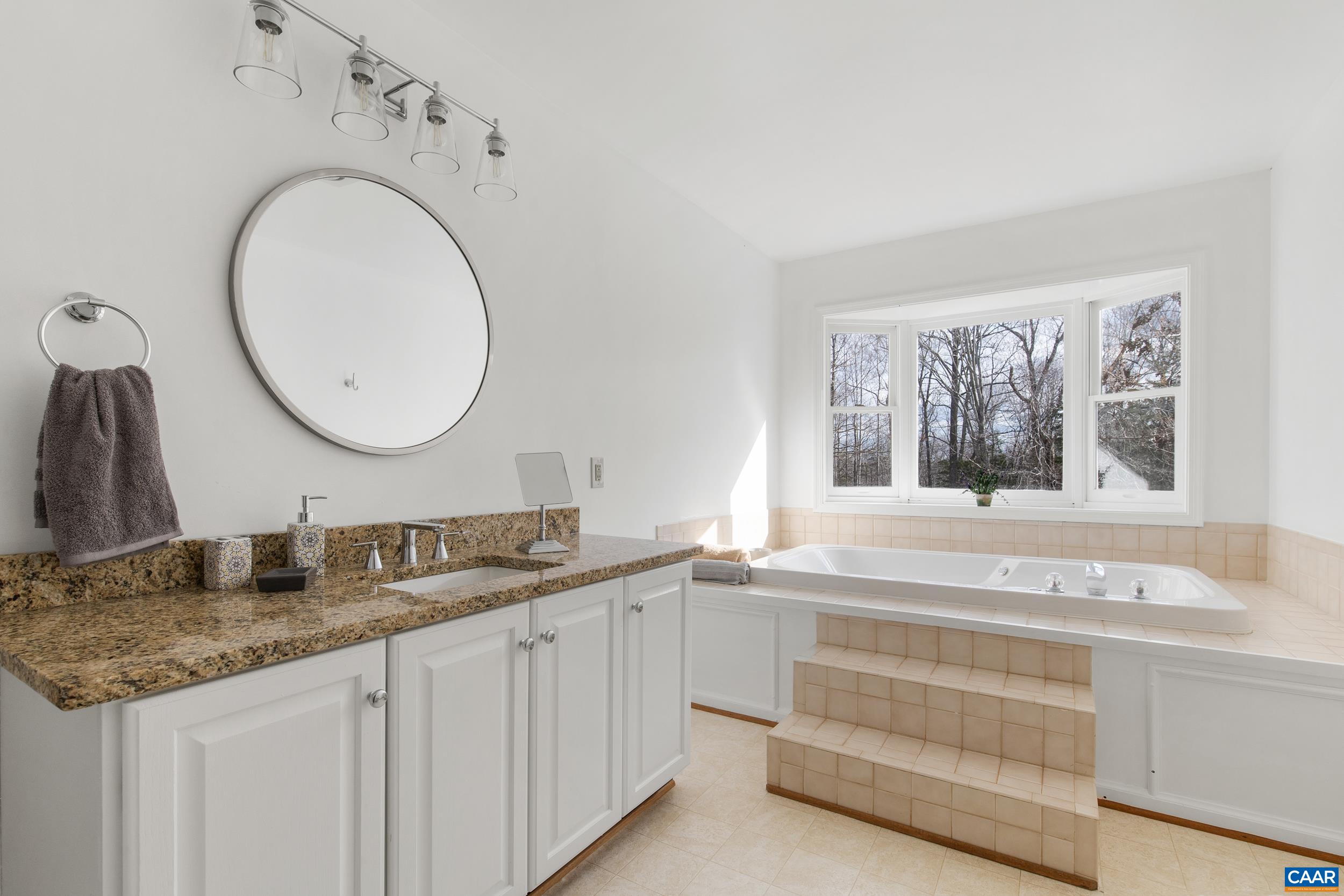 6883 Porters Road Esmont, VA 22937 - Photo 32 of 67 a bathroom with a granite countertop double vanity sink and a window