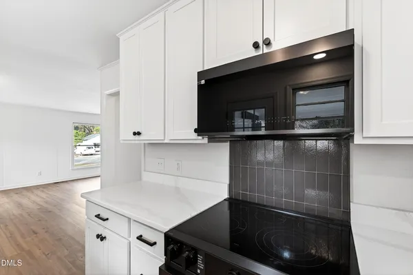 a kitchen with a microwave and a sink