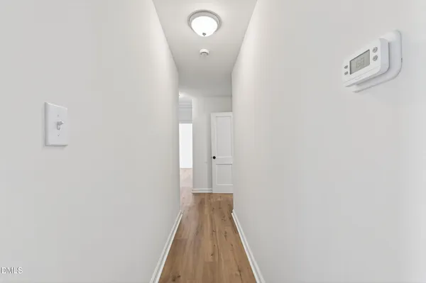 a view of a hallway with wooden floor