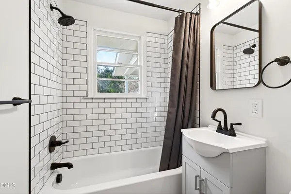 a bathroom with a sink a bathtub and shower
