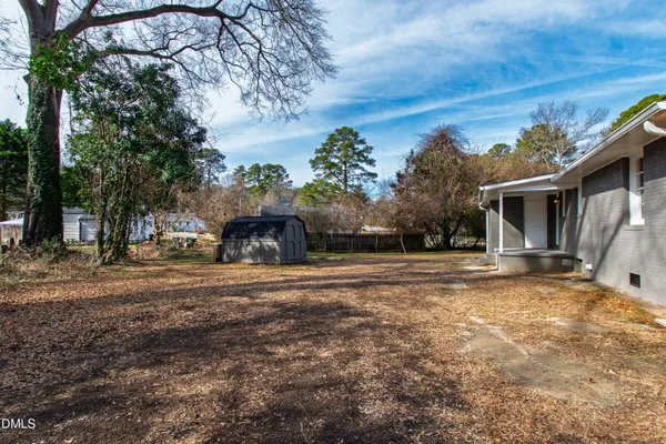 a front view of a house with a yard and a garage