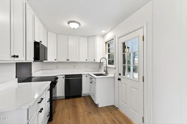 a kitchen with a sink stove and cabinets