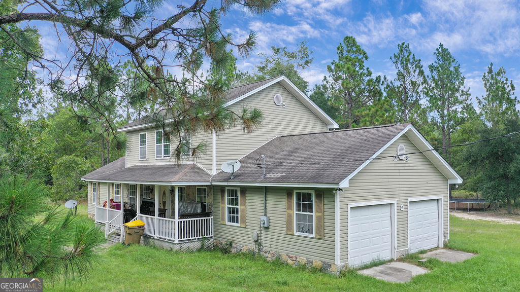 680 Groveland Nevils Road Pembroke, GA 31321 - Photo 1 of 1 a view of a house with a yard and plants