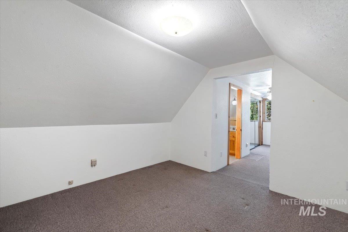 44 Ridgeview Drive Cascade, ID 83611 - Photo 14 of 29 Additional living space featuring carpet floors and a textured ceiling