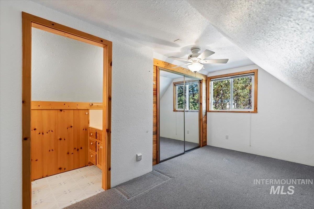 44 Ridgeview Drive Cascade, ID 83611 - Photo 16 of 29 Bonus room featuring light colored carpet, a ceiling fan, and a textured wall