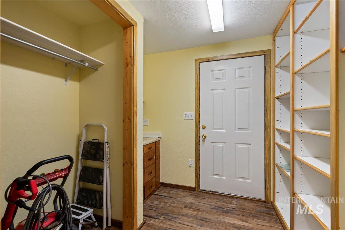 44 Ridgeview Drive Cascade, ID 83611 - Photo 21 of 29 Laundry area featuring dark wood-type flooring and a textured ceiling