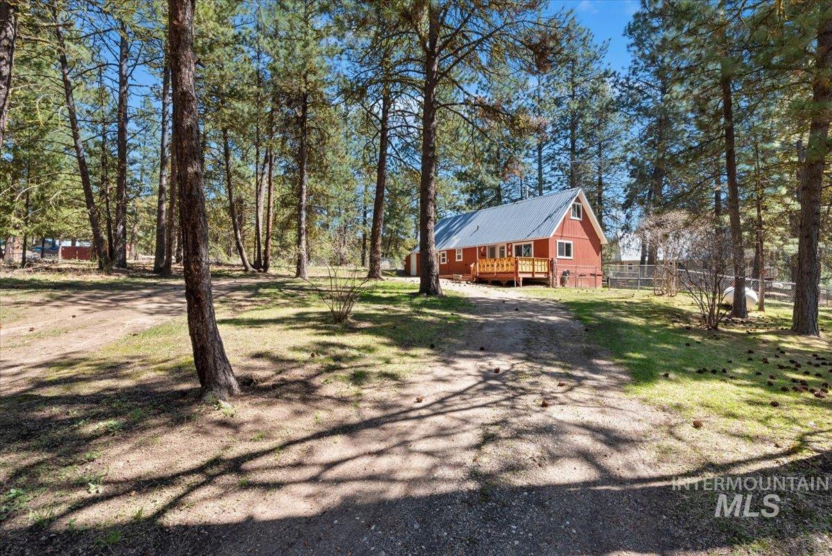 44 Ridgeview Drive Cascade, ID 83611 - Photo 27 of 29 View of front facade featuring a wooden deck, driveway, and a metal roof