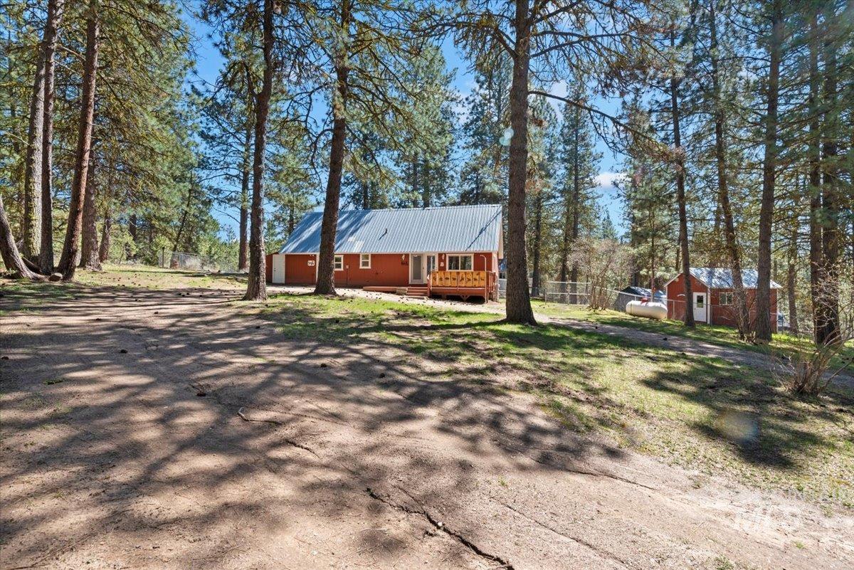 44 Ridgeview Drive Cascade, ID 83611 - Photo 28 of 29 View of front of home featuring dirt driveway, a metal roof, and a storage unit
