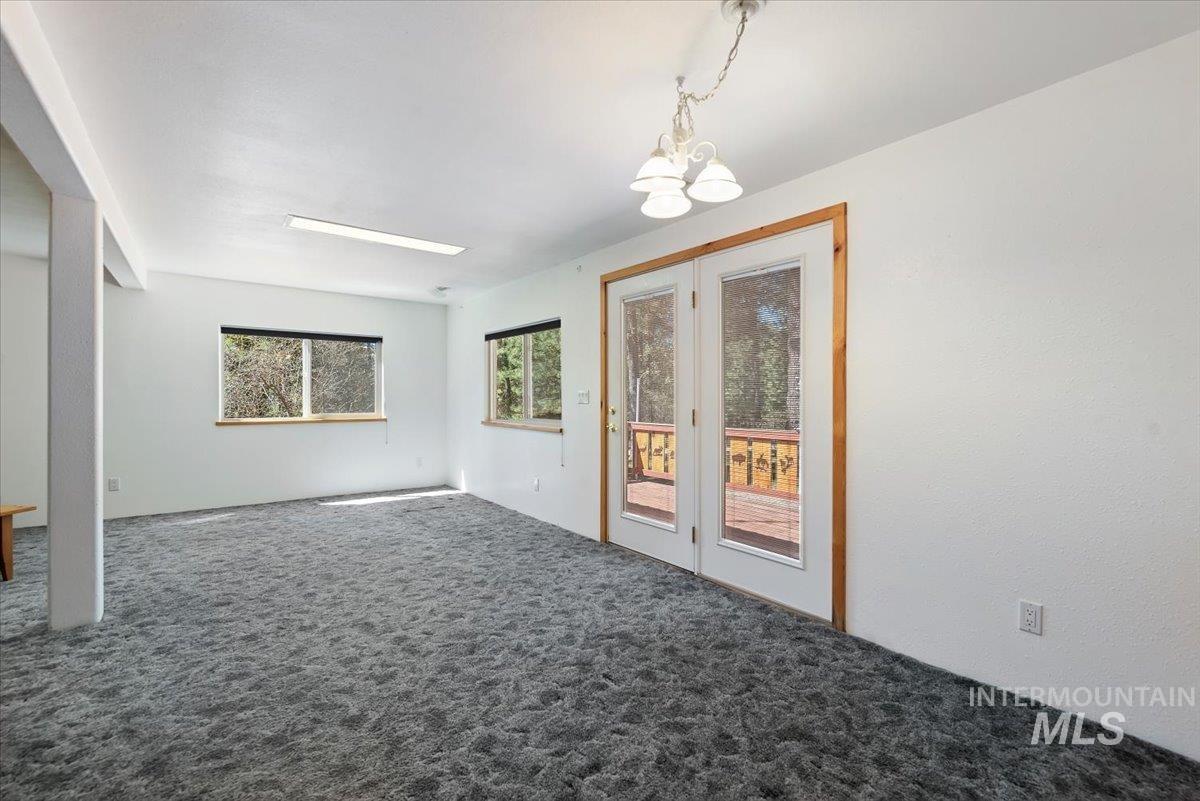 44 Ridgeview Drive Cascade, ID 83611 - Photo 9 of 29 Carpeted empty room featuring hanging lights