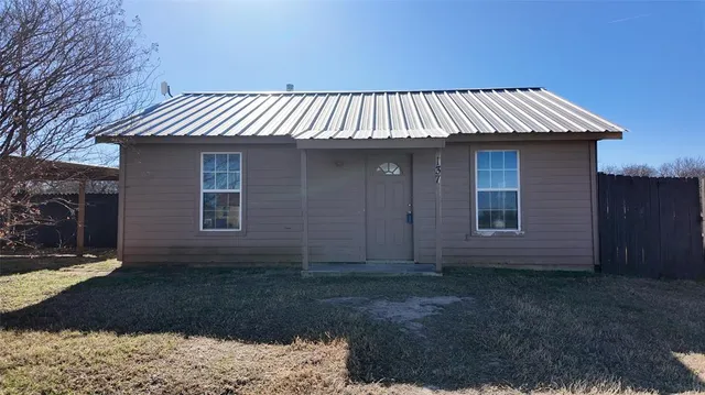 a view of a house with a yard and garage