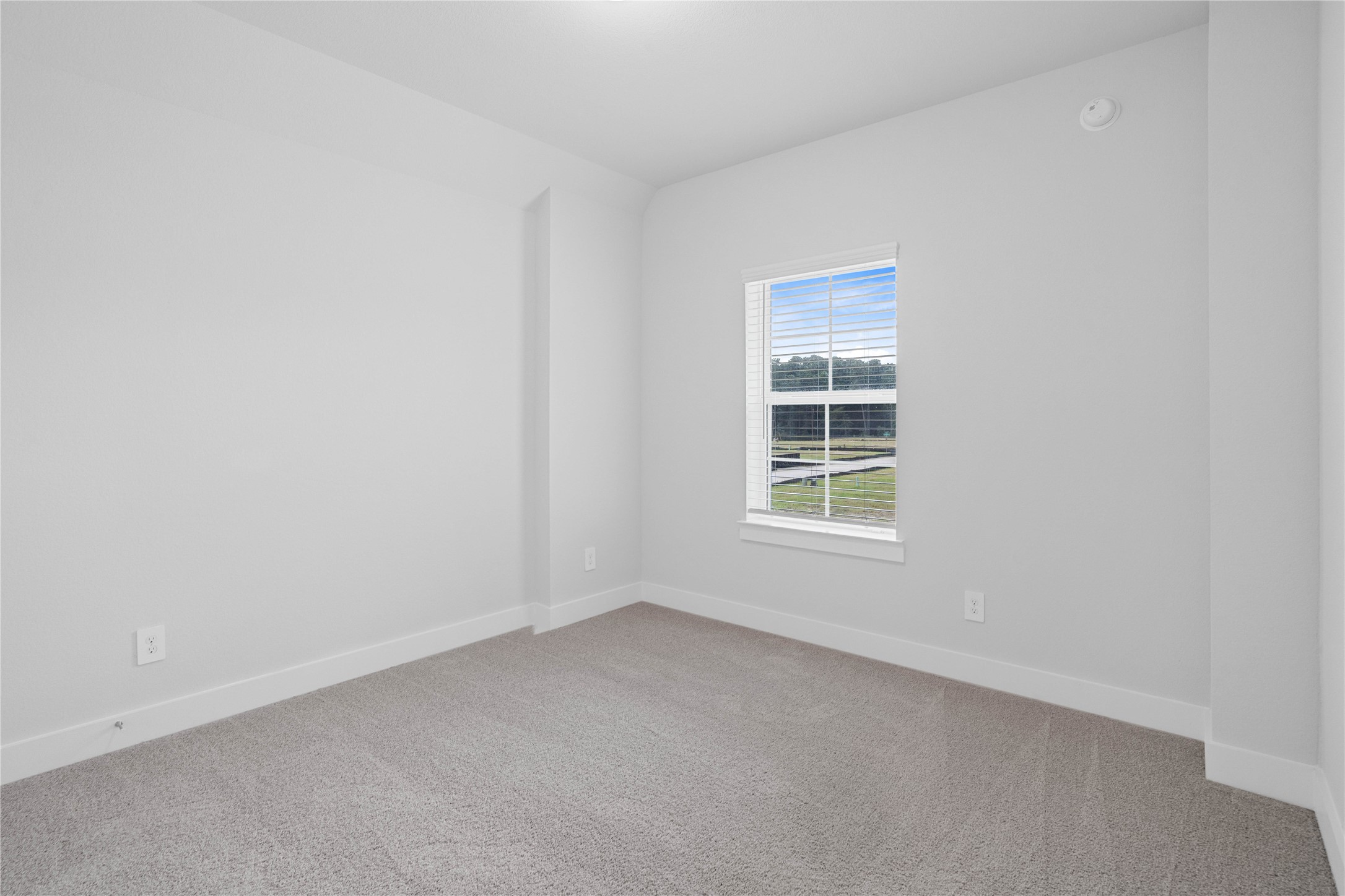 2035 Frst Strm Way Conroe, TX 77304 - Photo 39 of 45 Perfect for guests or a quiet home office, this room features soft plush carpeting, a window with fitted blinds, high ceiling, and ample sized closet space.