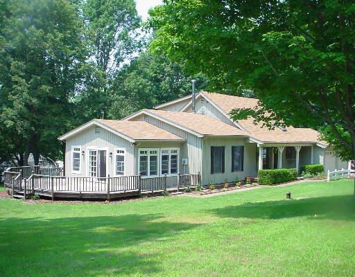 12 Blueberry Hill Road Bridgewater, CT 06752 - Photo 1 of 1 a front view of a house with a yard table and chairs