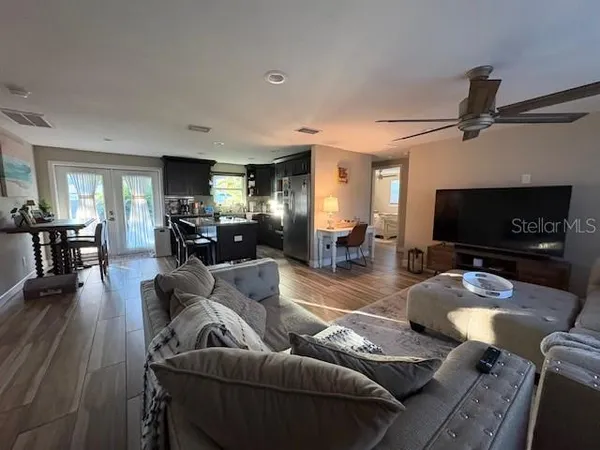 a bedroom with bed and wooden floor