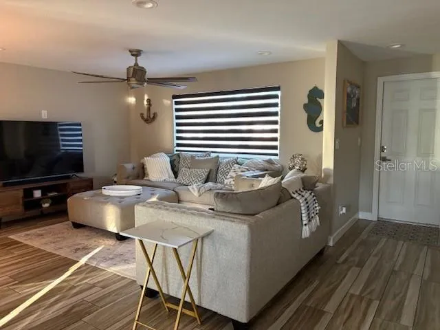 a living room with furniture a rug and white walls