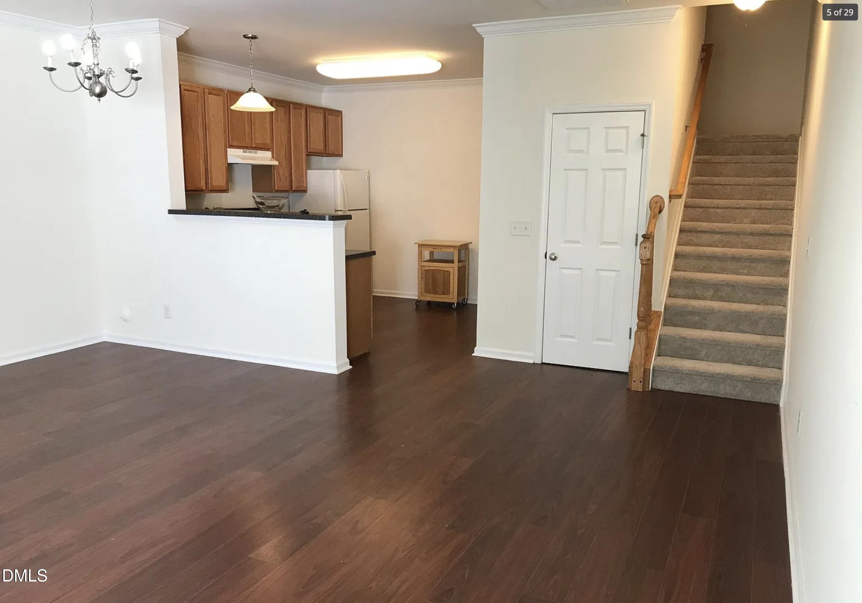 11730 Mezzanine Drive Raleigh, NC 27614 - Photo 2 of 11 a view of a hallway with wooden floor and staircase