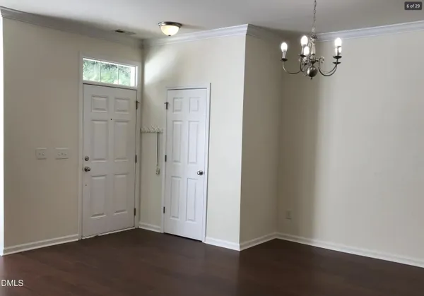 a view of a chandelier in big room and chandelier in a room