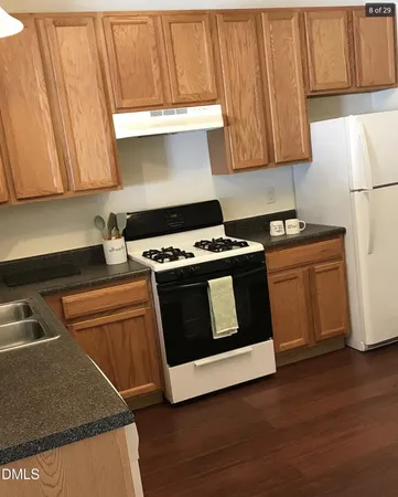 a kitchen with wooden cabinets and a stove top oven