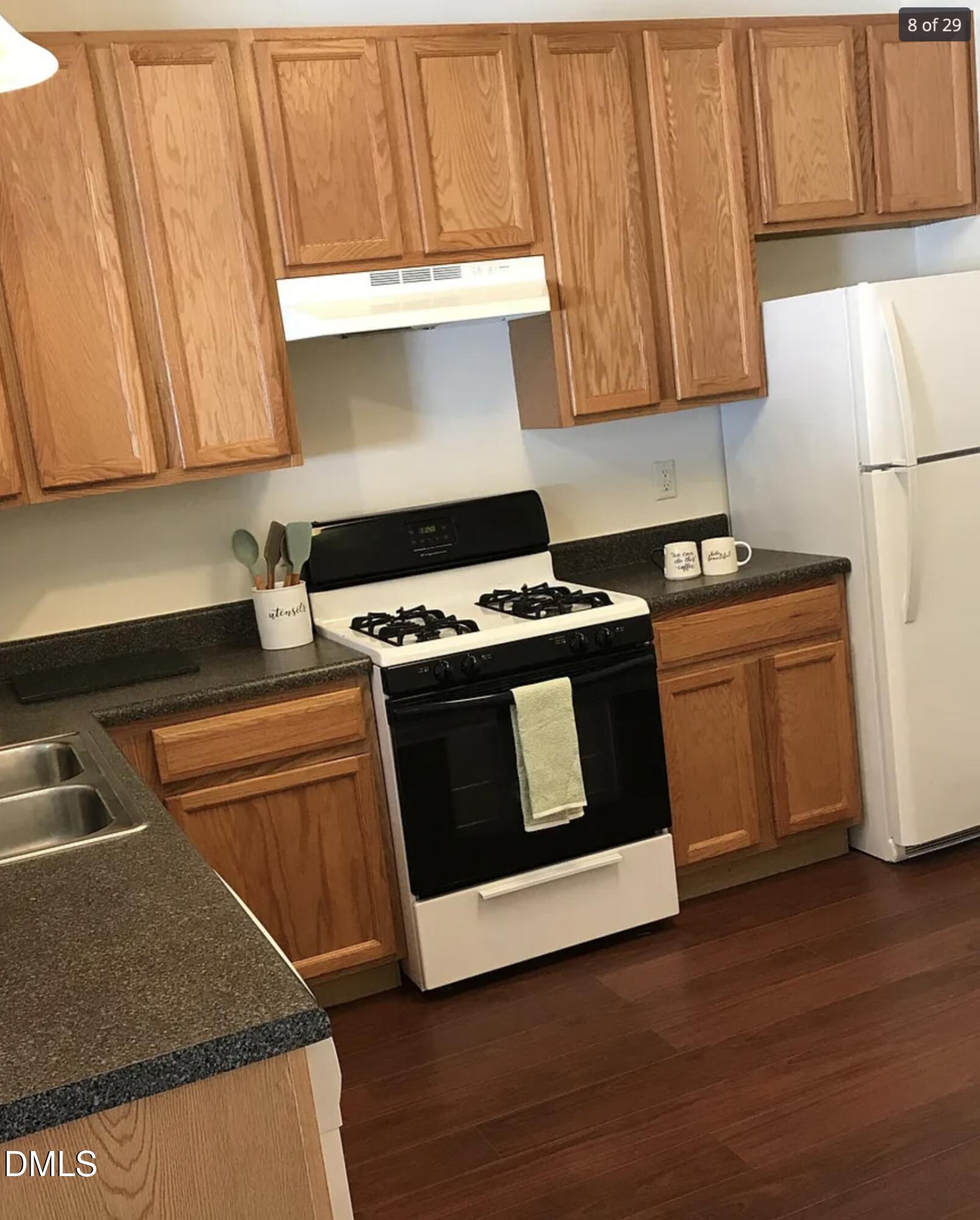 11730 Mezzanine Drive Raleigh, NC 27614 - Photo 7 of 11 a kitchen with wooden cabinets and a stove top oven