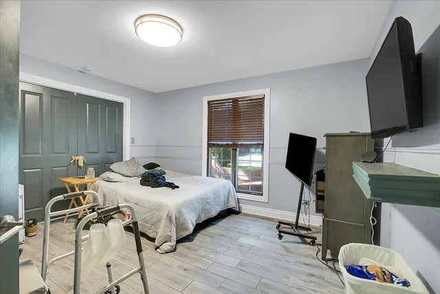 a bedroom with furniture and a flat screen tv