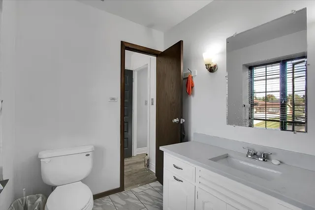 a bedroom with a bed and a chair