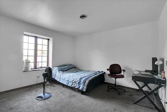 a bedroom with a bed and a table