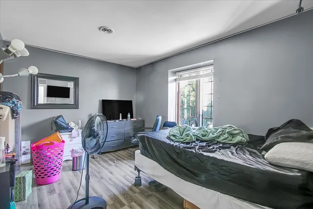 a bedroom with furniture and a window