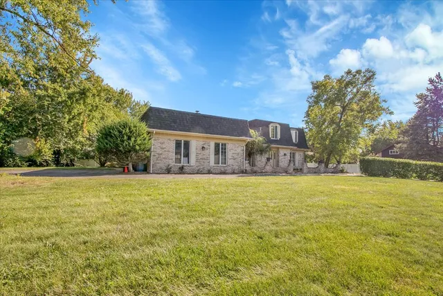a house view with swimming pool in front of it