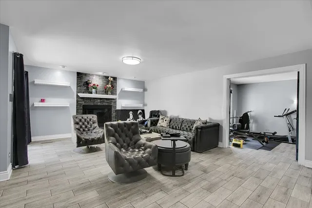 a living room with furniture a mirror and a fireplace