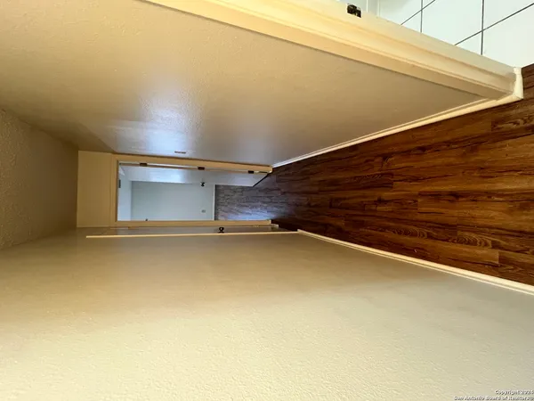 a view of a room with wooden floor and staircase