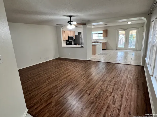 wooden floor in an empty room with a window