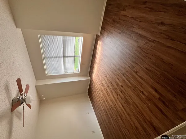 a view of room with window and wooden floor
