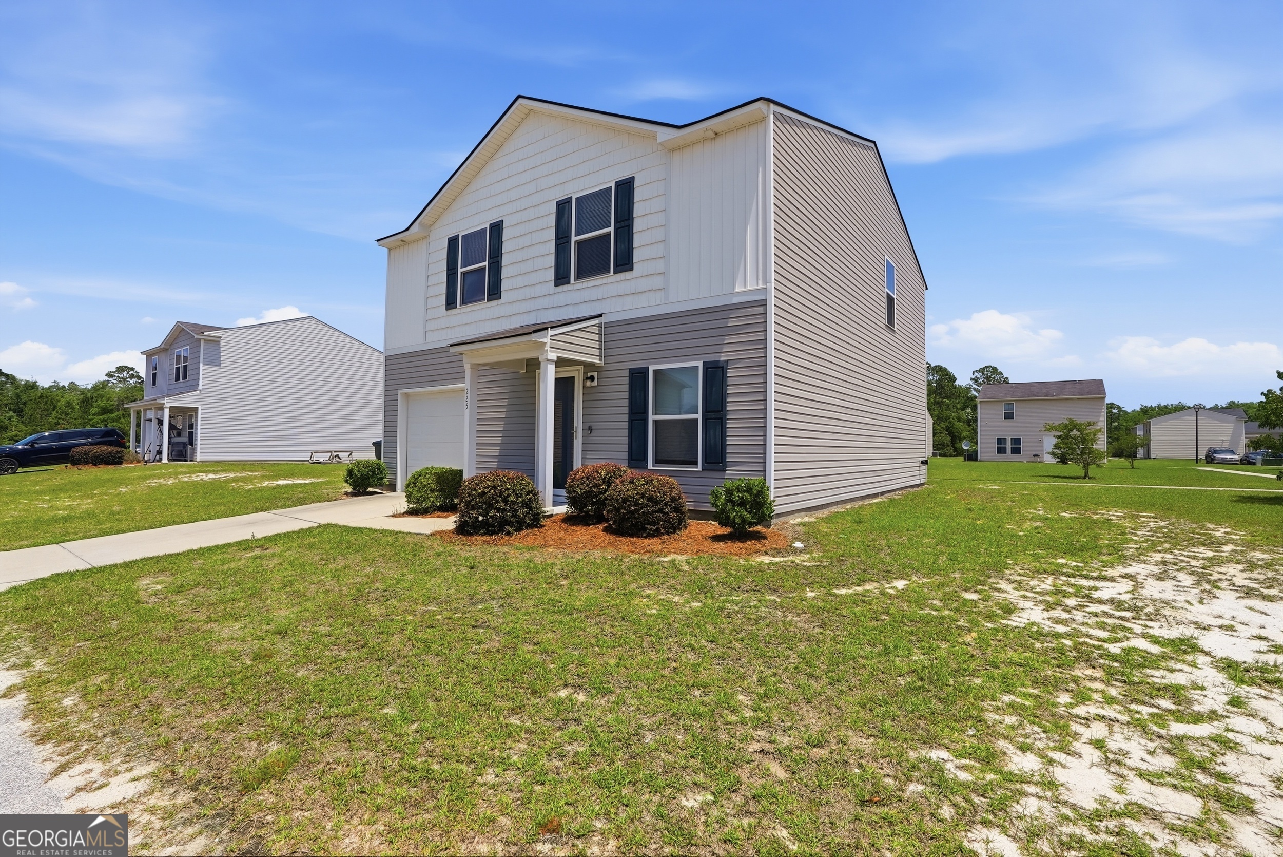 225 Rendell Lane Hinesville, GA 31313 - Photo 3 of 33 a view of a house with backyard porch and sitting area