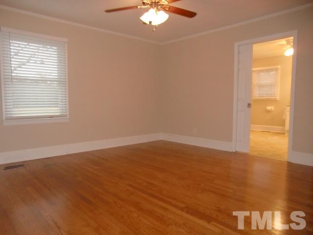 302 Jackson Road Dunn, NC 28334 - Photo 17 of 25 Master Bedroom has a Double Closet, Hardwood Floor, Large Pocket Door to Full Bath with Double Vanities, 5FT Shower with Frameless Glass Doors, Linen Closet, New Fixtures, Vinyl Floor.