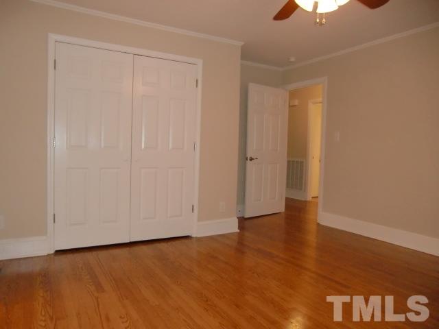 302 Jackson Road Dunn, NC 28334 - Photo 18 of 25 Master Bedroom has a Double Closet, Hardwood Floor, Large Pocket Door to Full Bath with Double Vanities, 5FT Shower with Frameless Glass Doors, Linen Closet, New Fixtures, Vinyl Floor.