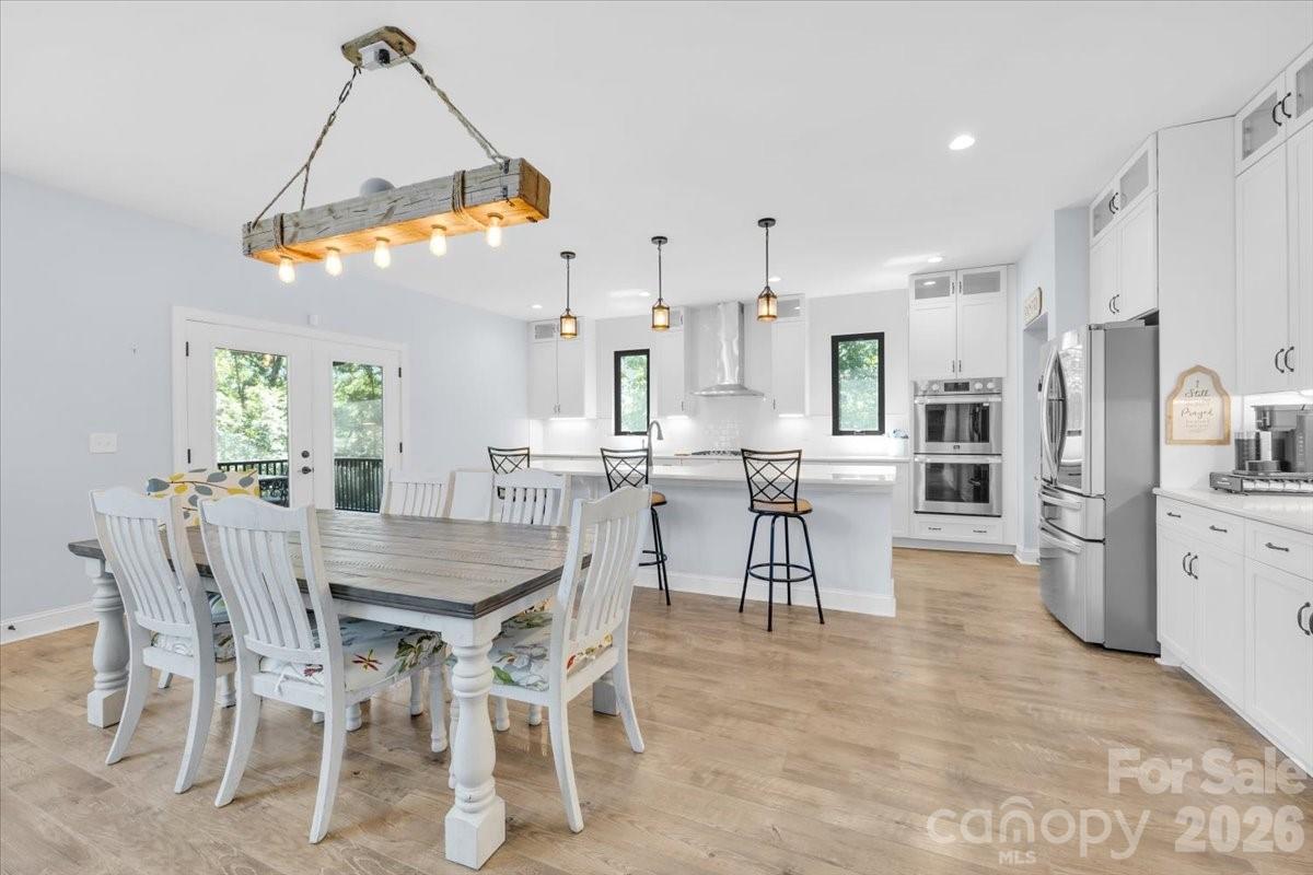 1194 99 Island Road Blacksburg, SC 29702 - Photo 12 of 47 a kitchen with stainless steel appliances kitchen island granite countertop a dining table chairs and white cabinets