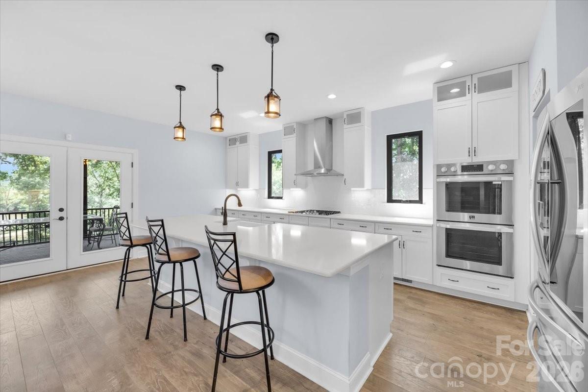 1194 99 Island Road Blacksburg, SC 29702 - Photo 13 of 47 a kitchen with stainless steel appliances granite countertop a stove a sink a refrigerator and a dining table with wooden floor